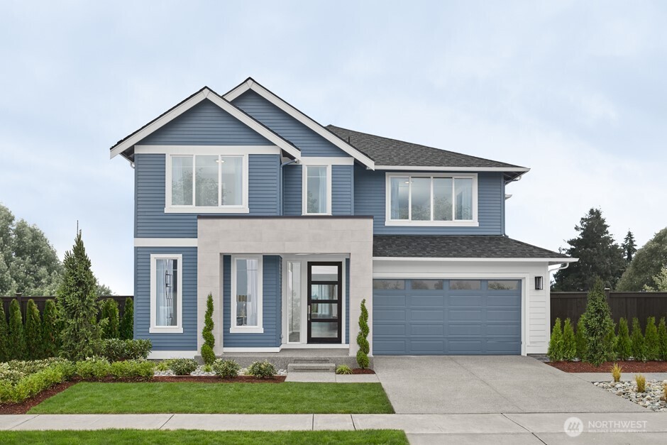 a front view of a house with a yard and garage