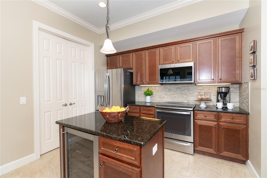 10501 Amberjack Way, Unit 402 Englewood, FL 34224 - Photo 12 of 45 a kitchen with stainless steel appliances granite countertop a sink stove microwave and refrigerator