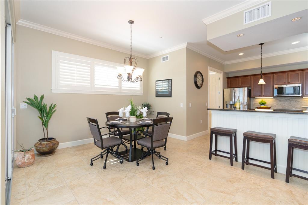 10501 Amberjack Way, Unit 402 Englewood, FL 34224 - Photo 15 of 45 a view of a dining room with furniture and chandelier