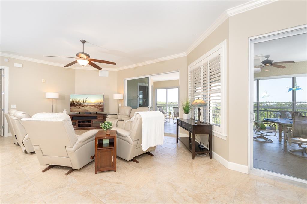 10501 Amberjack Way, Unit 402 Englewood, FL 34224 - Photo 17 of 45 a living room with furniture and a large window