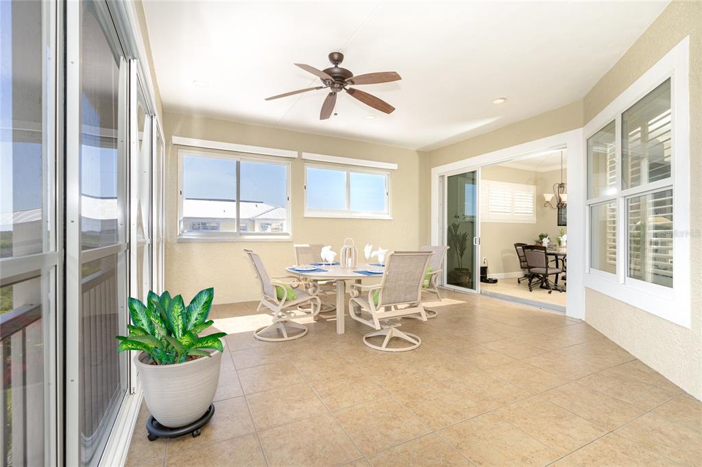 10501 Amberjack Way, Unit 402 Englewood, FL 34224 - Photo 18 of 45 a view of a dining room with furniture a potted plant and a chandelier