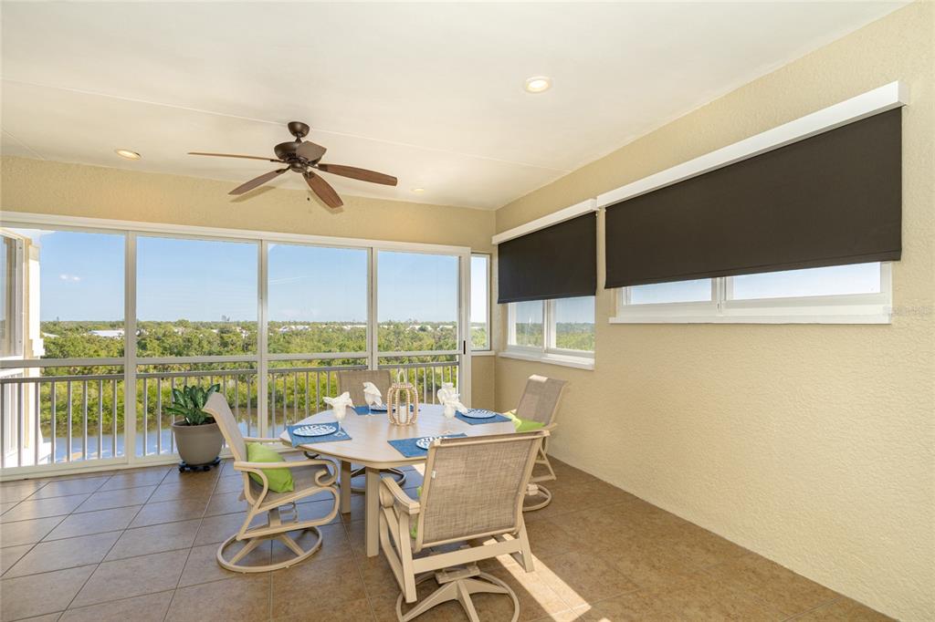10501 Amberjack Way, Unit 402 Englewood, FL 34224 - Photo 20 of 45 a dining room with furniture and a floor to ceiling window
