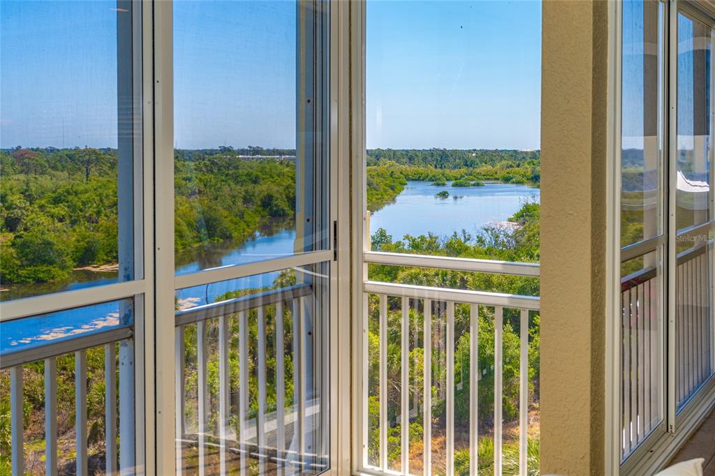 10501 Amberjack Way, Unit 402 Englewood, FL 34224 - Photo 24 of 45 a view of a balcony with a floor to ceiling window next to a road