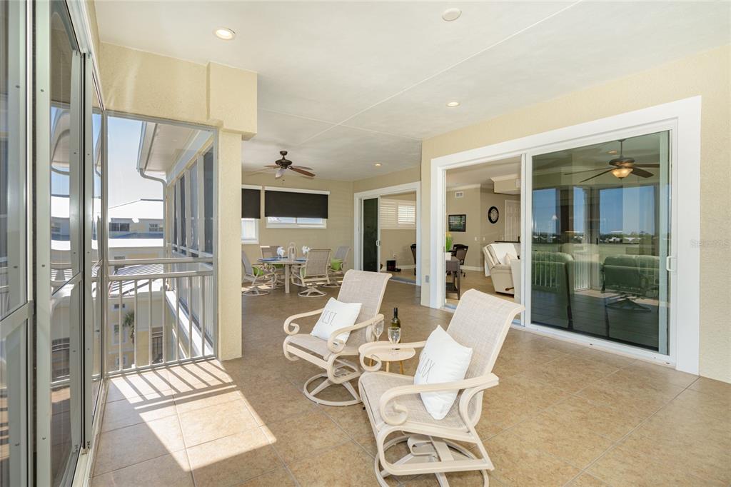 10501 Amberjack Way, Unit 402 Englewood, FL 34224 - Photo 25 of 45 a view of a living room and a balcony