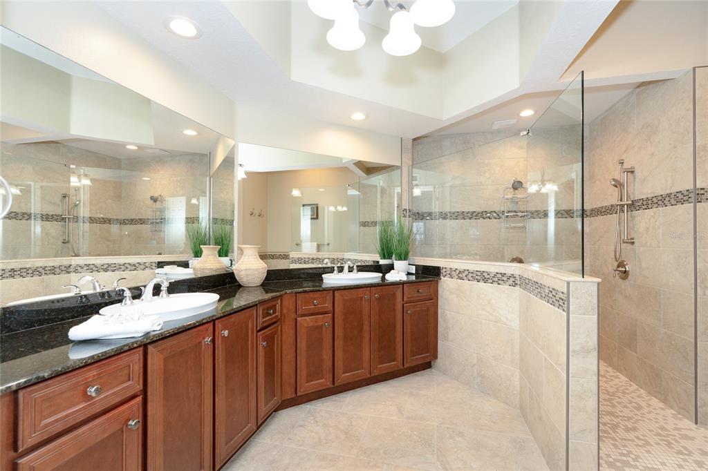 10501 Amberjack Way, Unit 402 Englewood, FL 34224 - Photo 28 of 45 a large bathroom with a double vanity sink and a mirror