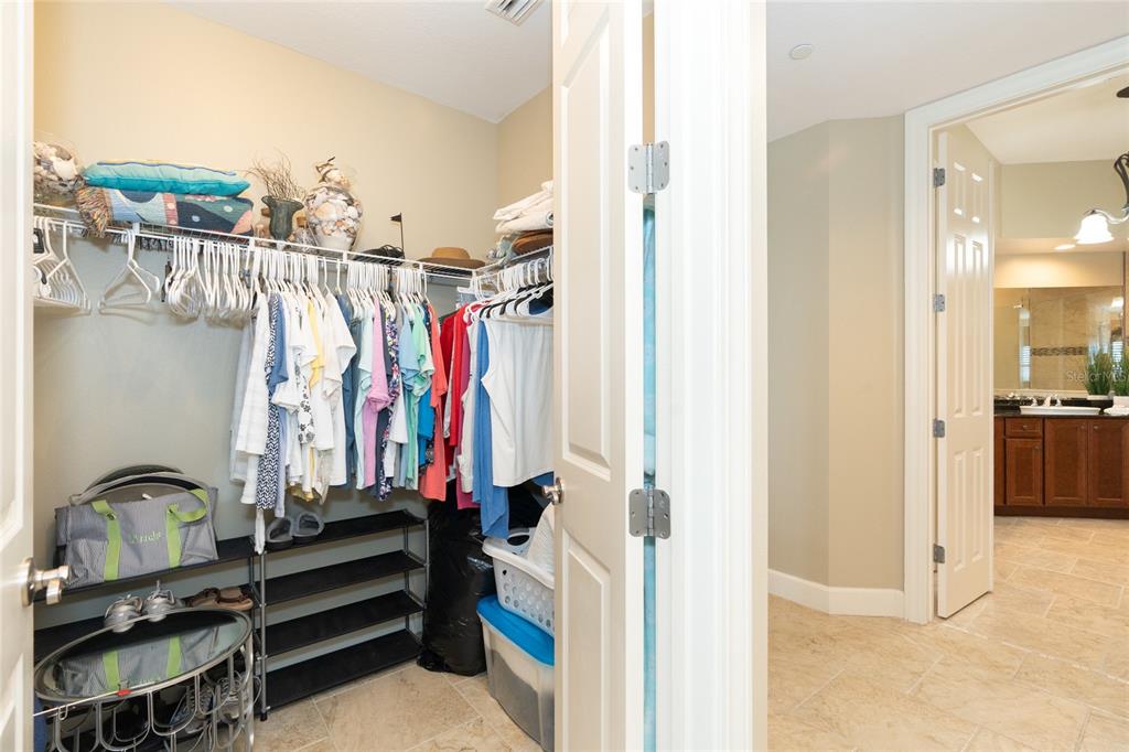 10501 Amberjack Way, Unit 402 Englewood, FL 34224 - Photo 30 of 45 a view of walk in closet with clothes and shoes