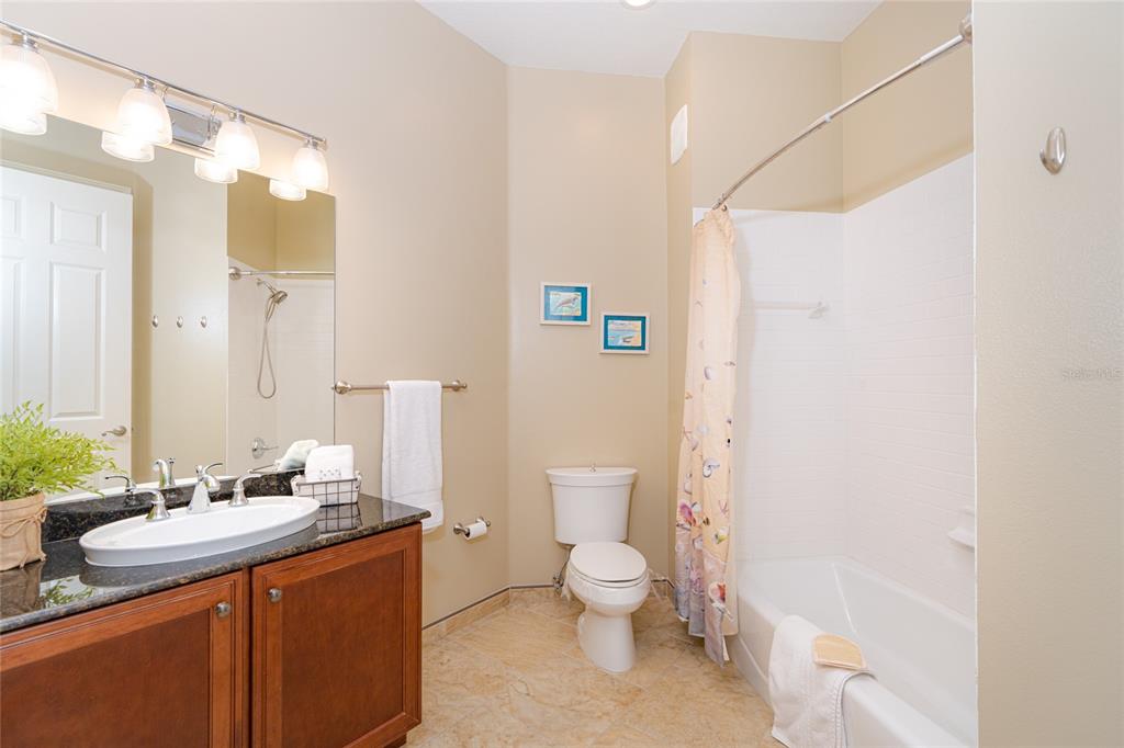 10501 Amberjack Way, Unit 402 Englewood, FL 34224 - Photo 34 of 45 a bathroom with a granite countertop sink mirror vanity and toilet