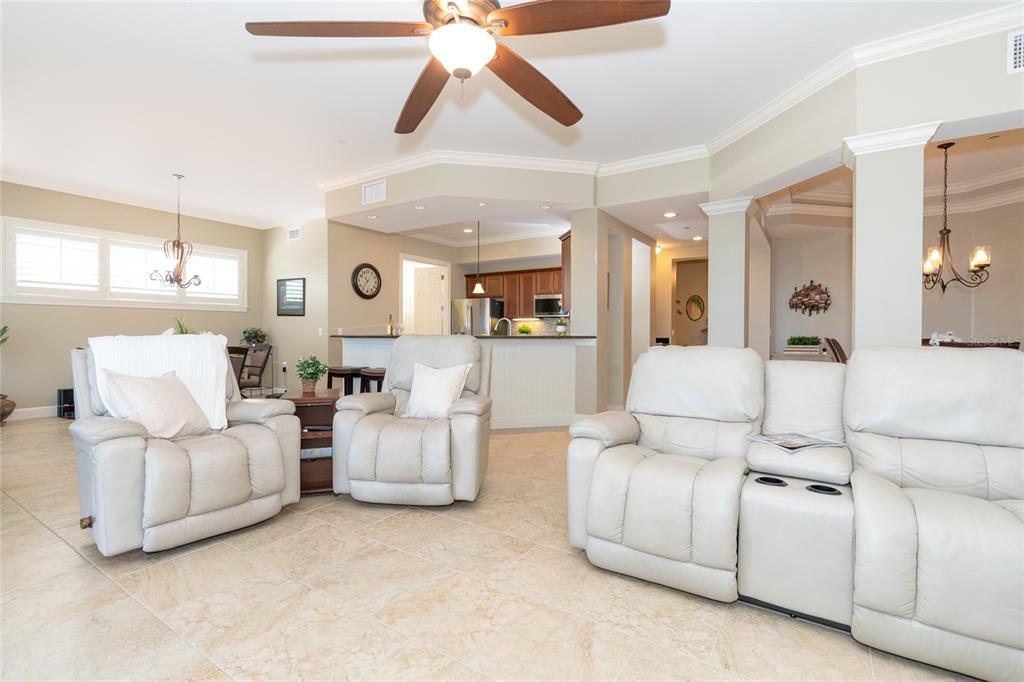 10501 Amberjack Way, Unit 402 Englewood, FL 34224 - Photo 4 of 45 a living room with furniture and a chandelier