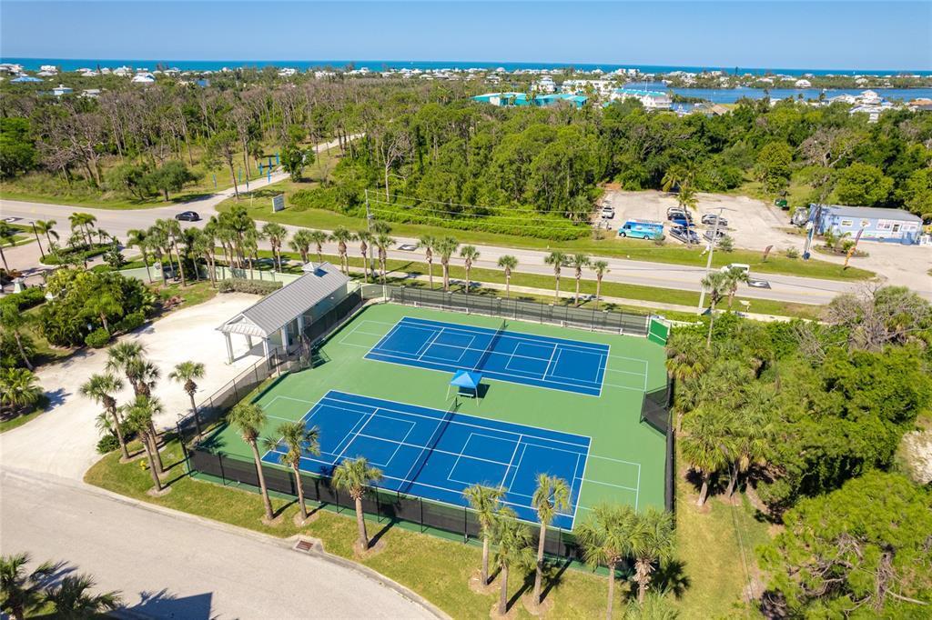 10501 Amberjack Way, Unit 402 Englewood, FL 34224 - Photo 41 of 45 a view of a swimming pool with lawn chairs