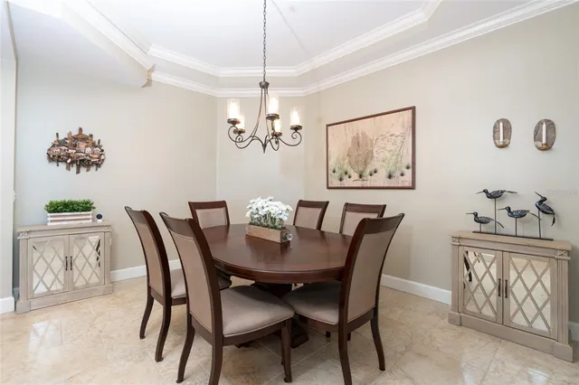 a view of a dining room with furniture and a chandelier