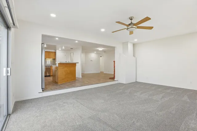 a view of an empty room with a kitchen