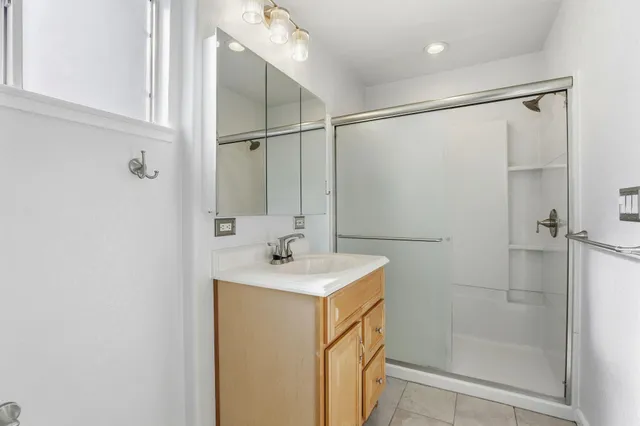 a view of a yard in front of a house with large trees