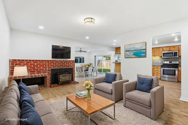 a living room with furniture a fireplace and a flat screen tv