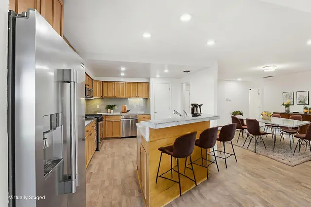 a large kitchen with a table and chairs