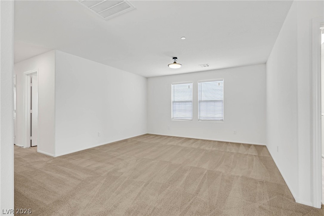 155 Fulgora Street Henderson, NV 89074 - Photo 8 of 30 A spacious room offers comfortable carpeting, ready for personalization.
