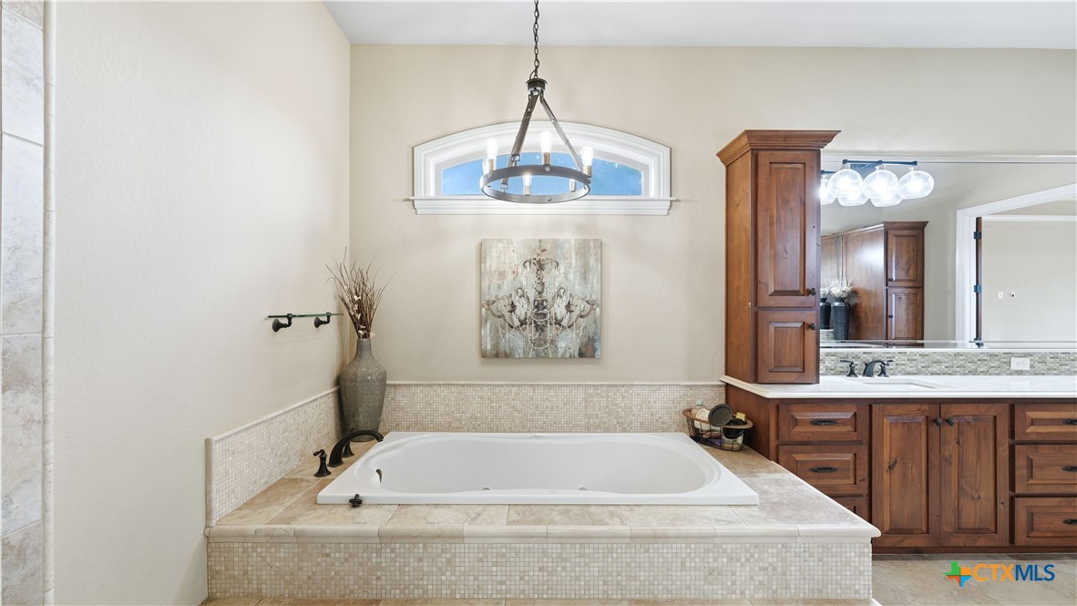 1035 Thunderbolt Rd Canyon Lake Canyon Lake, TX 78133 - Photo 37 of 48 a bathroom with a bathtub and a sink