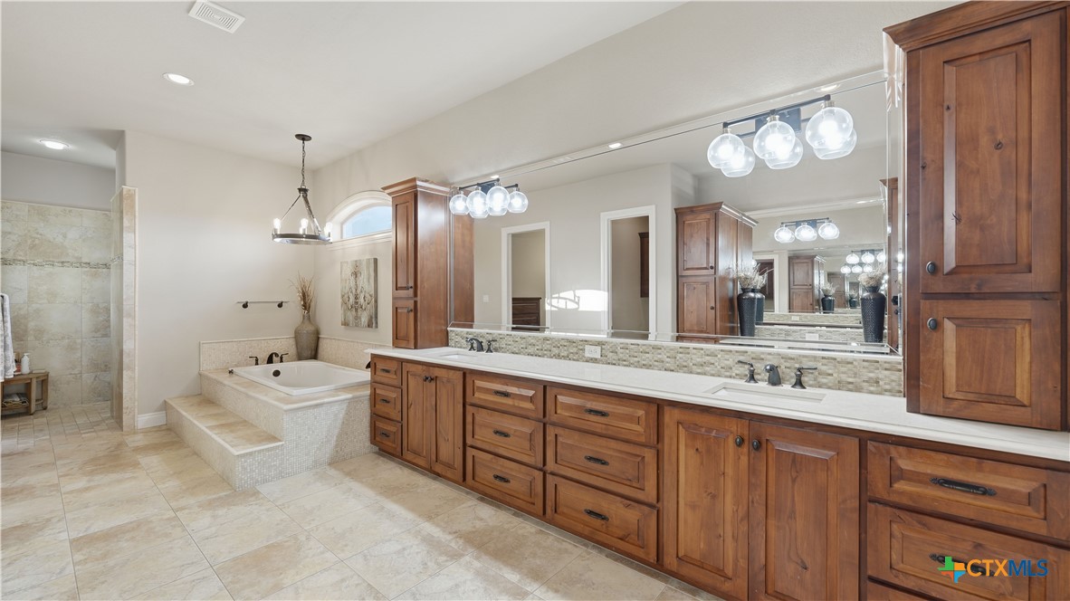 1035 Thunderbolt Rd Canyon Lake Canyon Lake, TX 78133 - Photo 39 of 48 a spacious bathroom with a granite countertop sink mirror and bathtub