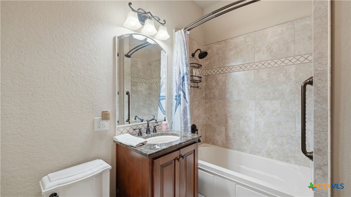 1035 Thunderbolt Rd Canyon Lake Canyon Lake, TX 78133 - Photo 42 of 48 a bathroom with a granite countertop sink toilet and shower