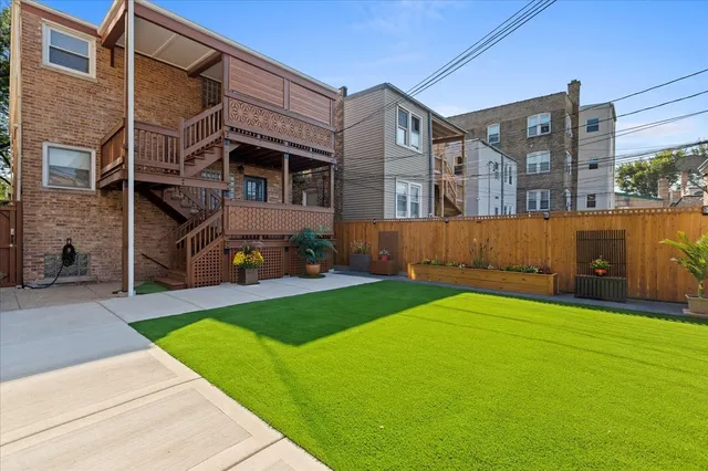 a front view of a house with a garden and seating area