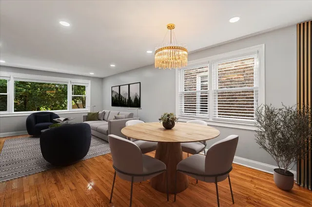 a view of a dining room with furniture wooden floor and chandelier