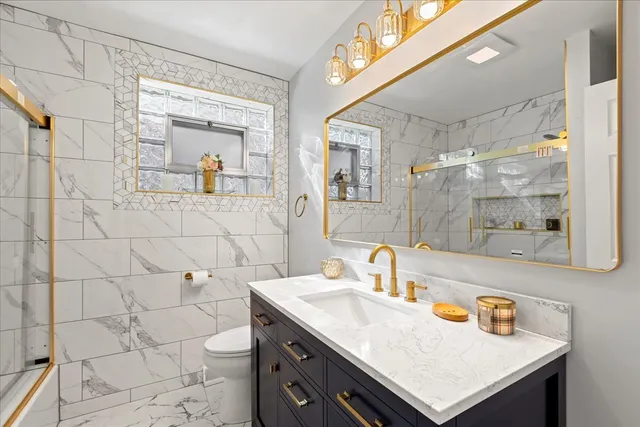 a bathroom with a sink mirror and shower