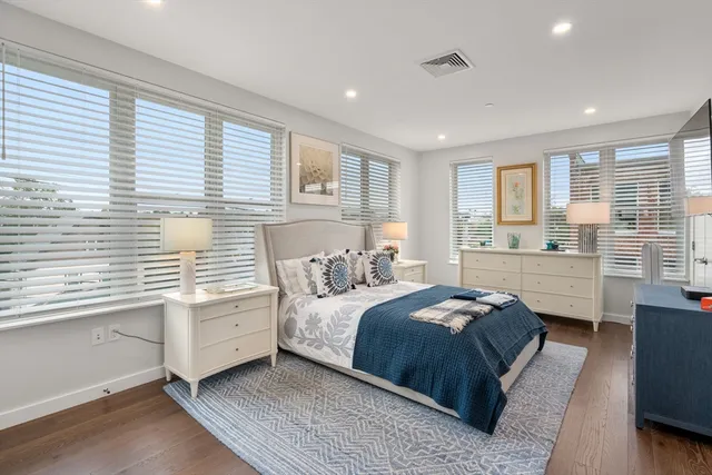 a bedroom with a large bed and a window