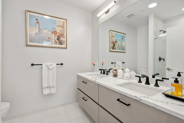 a bathroom with a double vanity sink and a mirror