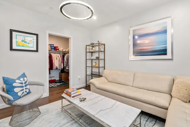 a living room with furniture and a bookshelf