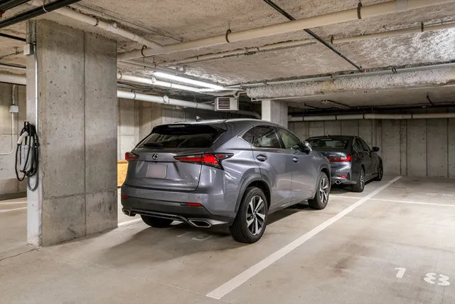 a view of parking garage with cars parked