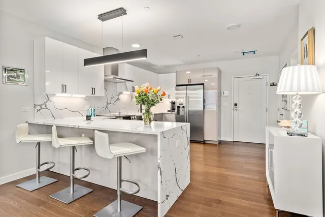 a living room with kitchen island furniture and a chandelier