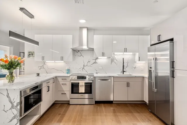 a kitchen with stainless steel appliances a white cabinets and sink