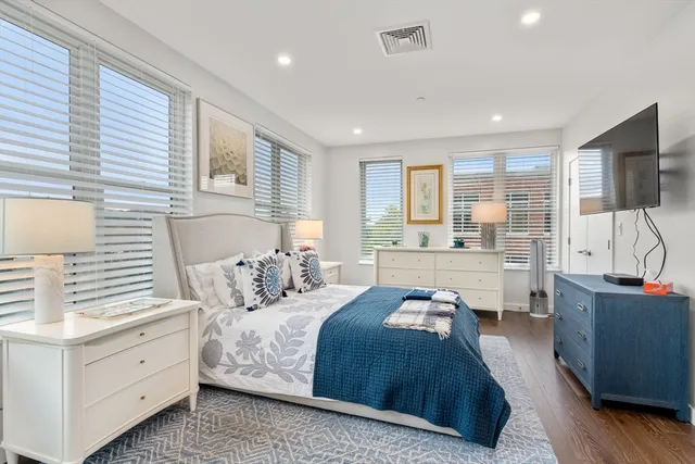 a bedroom with a large bed and a large window
