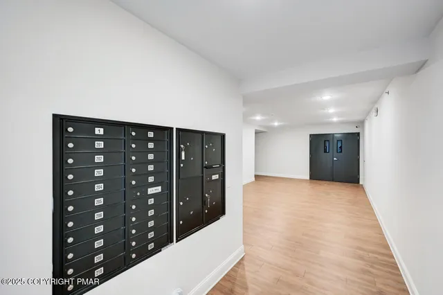 a view of hallway with wooden floor