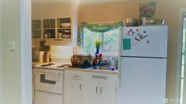 a kitchen with a refrigerator and a stove