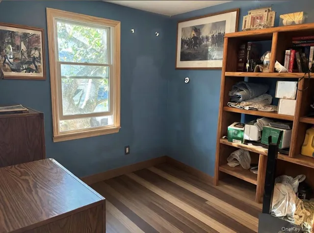 a room with a mirror and a wooden floor