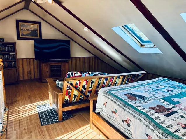 a room with lots of wooden floor a dining table and chairs