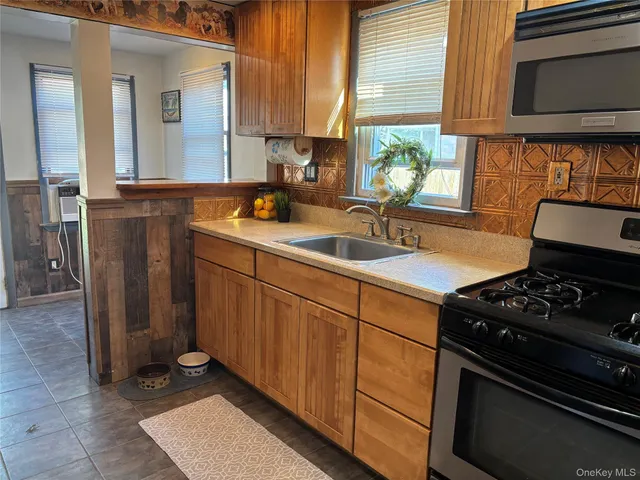 a kitchen with a sink stove and cabinets