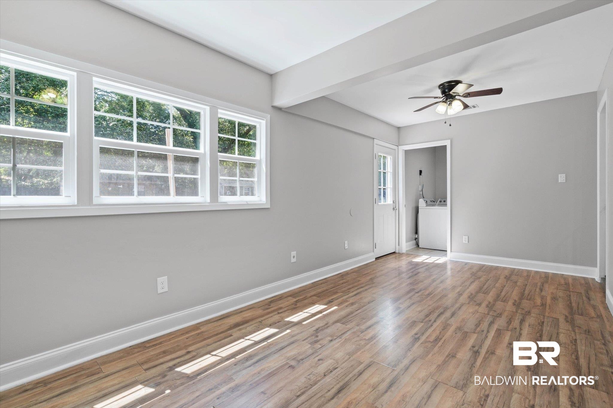 5609 Diane Court Mobile, AL 36618 - Photo 11 of 22 Unfurnished room with wood finished floors, washer / clothes dryer, and a ceiling fan