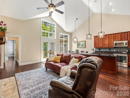 a living room with furniture ceiling fan and a rug
