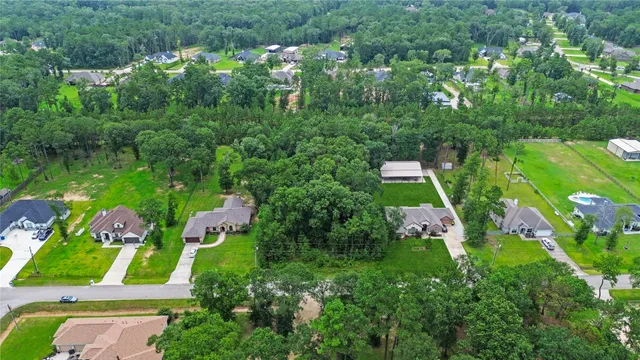 an aerial view of a house with a yard basket ball court and outdoor seating