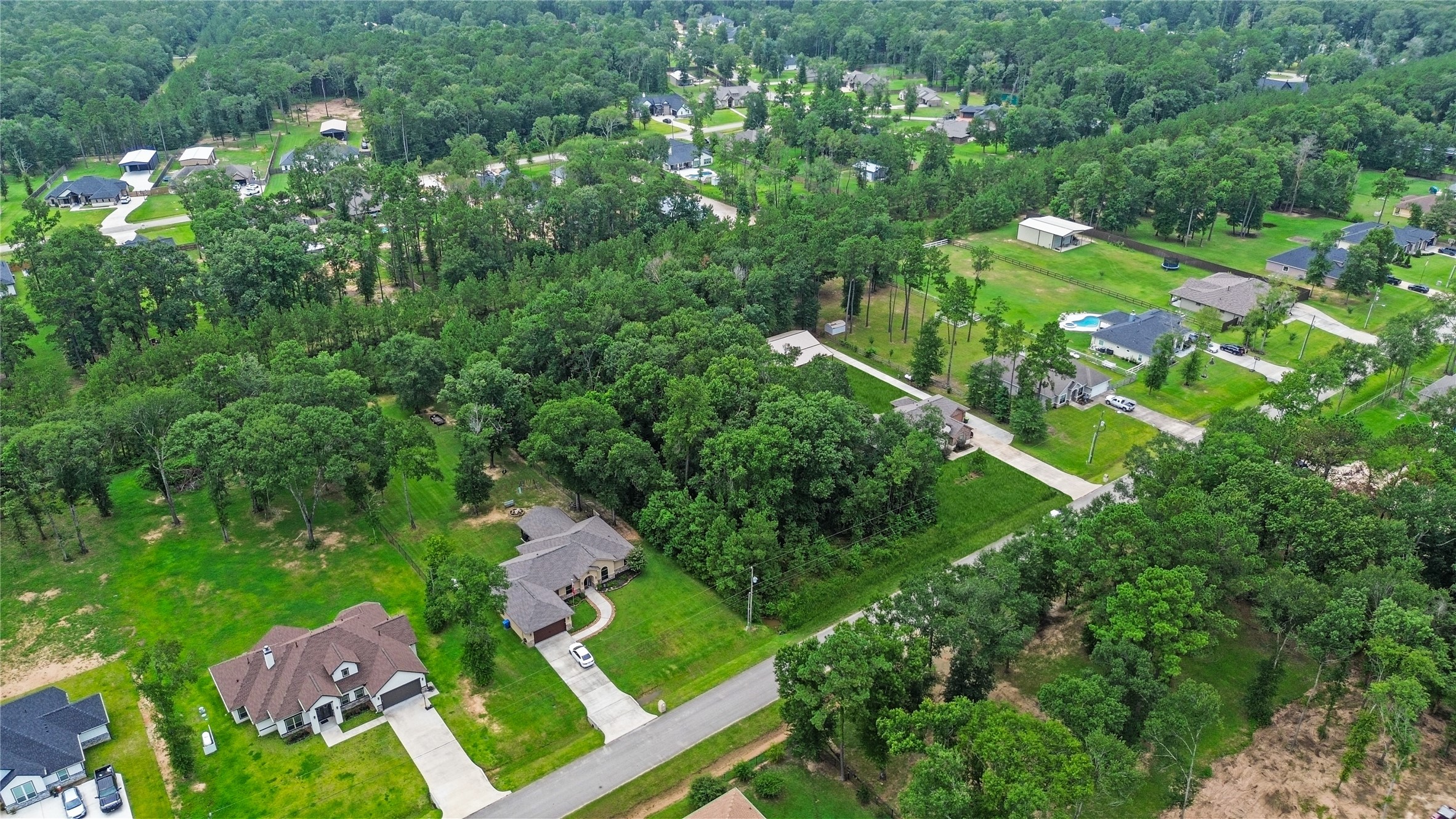 27692 Rio Blanco Drive Splendora, TX 77372 - Photo 3 of 11 an aerial view of residential houses with outdoor space and trees all around