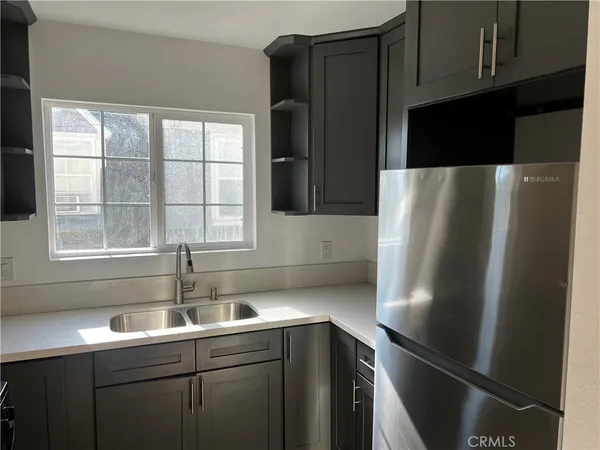 a kitchen with stainless steel appliances a refrigerator and a sink