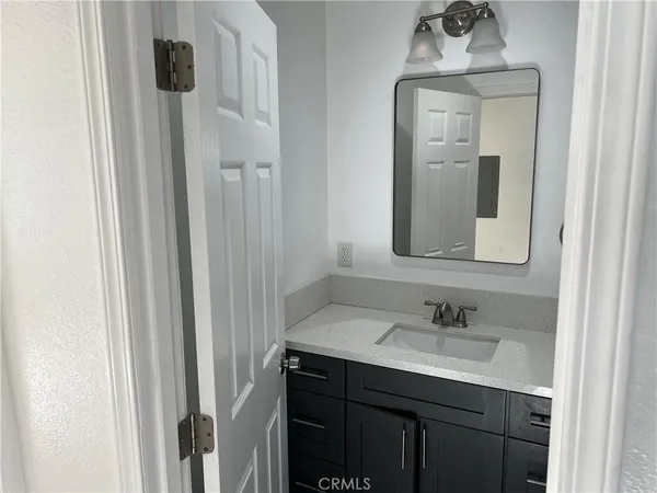 a bathroom with a sink vanity and a mirror