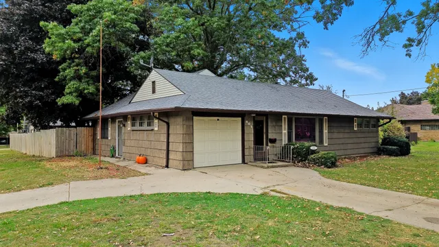 a view of a house with a yard and tree