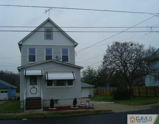 48 Lee Street Port Reading, NJ 07064 - Photo 1 of 4 a front view of a house with a yard