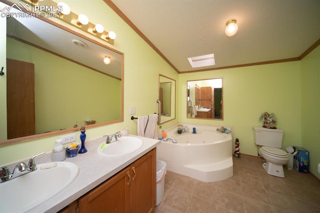 12495 Dan View Yoder, CO 80864 - Photo 14 of 40 a bathroom with a tub sink and mirror
