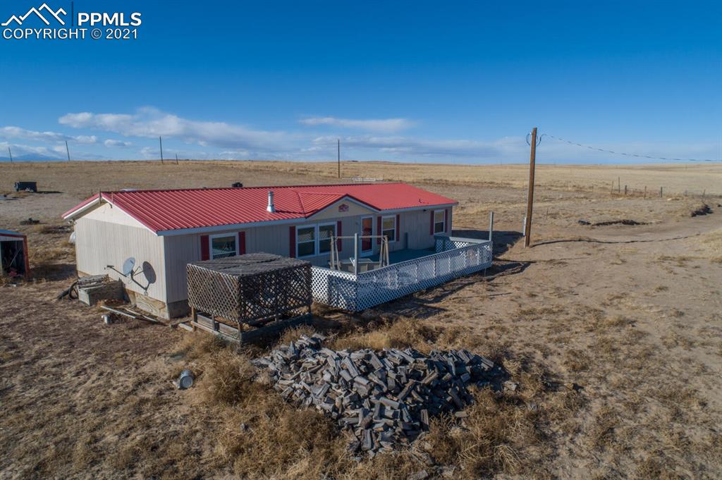12495 Dan View Yoder, CO 80864 - Photo 3 of 40 a view of a house with a yard