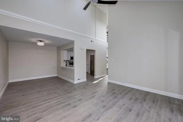 a view of a kitchen with wooden floor and a window