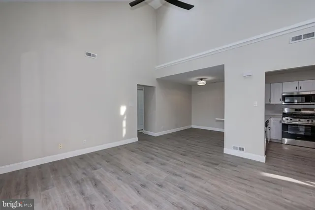 a view of empty room with wooden floor