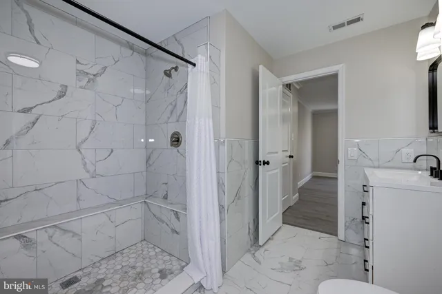 a bathroom with a sink and shower
